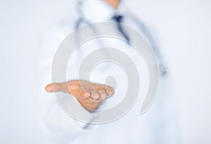 Male doctor holding something in his hand