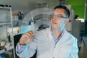 Male doctor holding a syringe in his hand