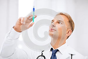 Male doctor holding syringe with injection