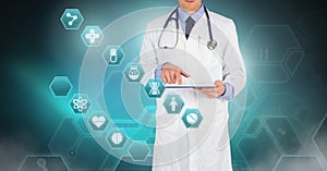 Male doctor holding tablet with medical interface hexagon icons