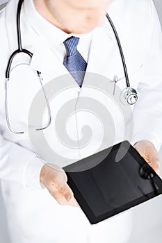 Male doctor holding tablet pc