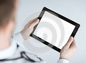 Male doctor holding tablet pc