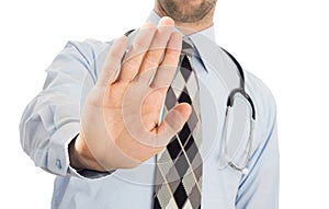 Male doctor holding up his hand in a Halt or Stop gesture