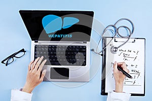 Male doctor with laptop and liver symbol