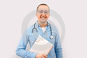 Male doctor looking at the camera with a laptop on a white background. Healthcare and medicine