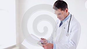 Male doctor making a prescription