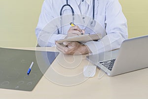 Male doctor,Medical professional use laptop computer,research and analyze,Disease analysis,record patient information With