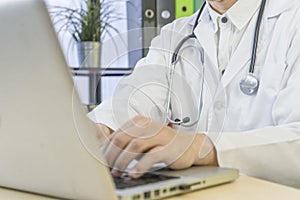 Male doctor,Medical professional use laptop computer,research and analyze,Disease analysis,record patient information With