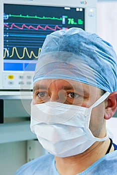Male doctor with monitor in ICU