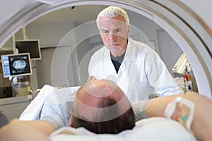 male doctor and patient tomographic scanner in hospital