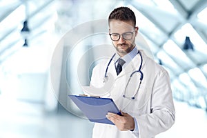 Male doctor portrait while working in the hospital photo