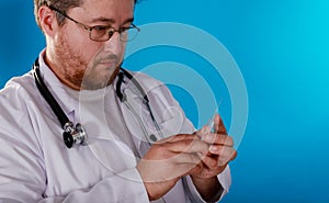 Male doctor preparing syringe in the hands