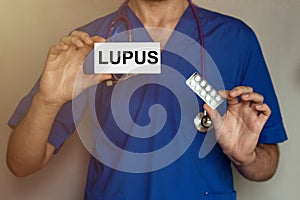 Male doctor prescribes prescription for pills Lupus photo