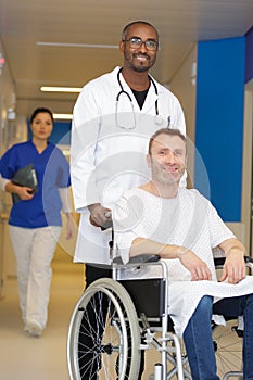 male doctor pushing patient on wheelchair