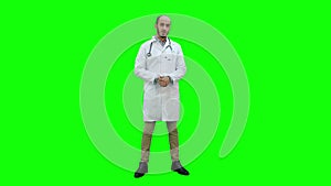 Male doctor seriously talking to the camera on a Green Screen, Chroma Key.