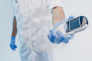 Male doctor showing electronic thermometer in hand