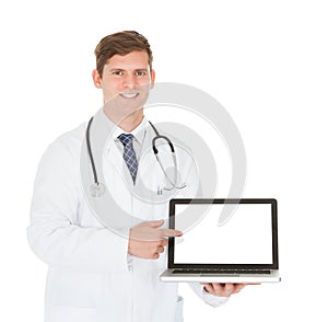 Male doctor showing on laptop