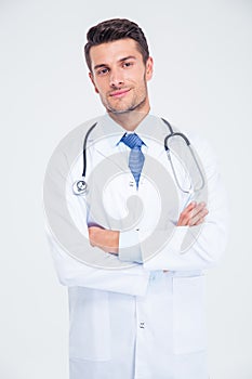 Male doctor standing with arms folded