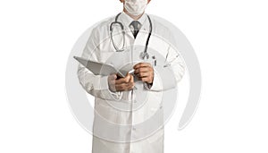 Male doctor standing in front of white background