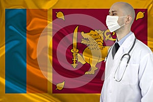 Male doctor with a stethoscope against the background of the silk national flag of sri lanka, concept of national medical care,