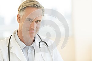 Male Doctor With Stethoscope Around Neck In Clinic