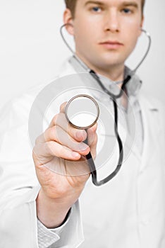 Male doctor with a stethoscope on white background