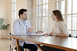 Male doctor talk consult female patient in hospital