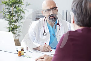 Male doctor talking to patient photo