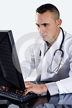 Male Doctor typing on computer