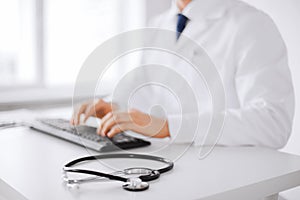 Male doctor typing on the keyboard