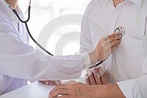 A male doctor undertaking patient consultations and physical examinations at the specialized hospital