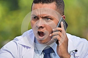 Male Doctor Using Cell Phone And Unhappy