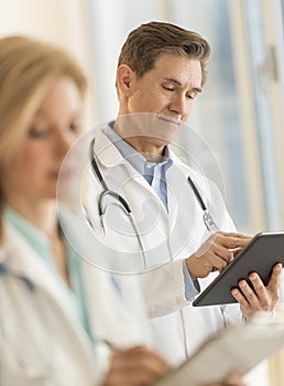 Male Doctor Using Digital Tablet At Hospital