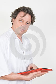 Male doctor using his digital tablet in the hospital