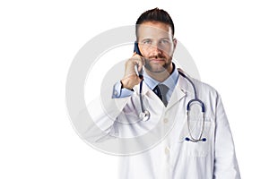 Male doctor using his phone while standing at isolated white background