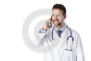 Male doctor using his phone while standing at isolated white background