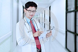 Male doctor using tablet in the hospital