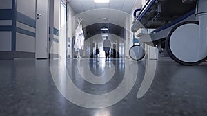 Male doctor walking through the long hallway