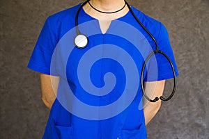 Male doctor wearing a blue uniform with a stethoscope