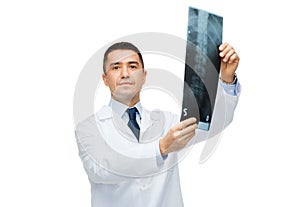 Male doctor in white coat holding x-ray