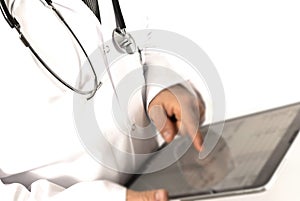 Male doctor in a white coat standing at the screen of a tablet computer in his hand