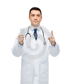 Male doctor in white coat with tablets