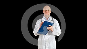 Male doctor in white coat writing on clip board on black background. Practitioner writing medical notes in clip board in