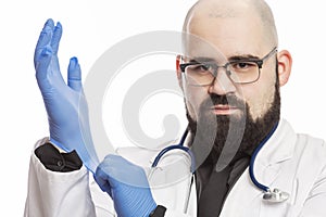 Male doctor in a white medical coat and blue latex gloves. White background. Close-up