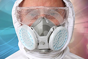 Male doctor in white protective suit, glasses and respirator close-up, concept of biohazard, emergency, SARS virus pandemic, COVID