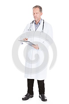 Male Doctor Writing On Clipboard