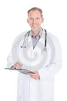 Male Doctor Writing On Clipboard