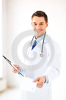 Male doctor writing prescription