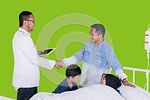 Male doctor and young man shaking hands