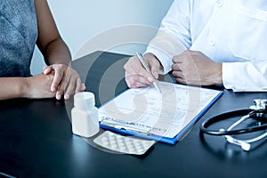 Male doctors explain and recommend treatment with a prescription after the patient meets a doctor and receives results regarding